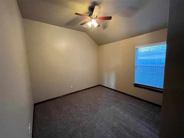 carpeted spare room featuring ceiling fan and lofted ceiling