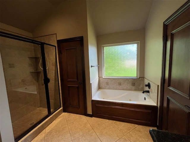 bathroom featuring tile patterned flooring, shower with separate bathtub, and lofted ceiling