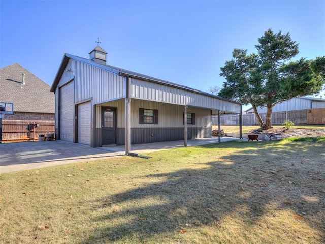 exterior space with an outbuilding, a garage, a carport, and a lawn