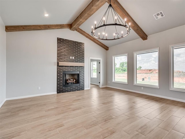 unfurnished living room featuring vaulted ceiling with beams, a chandelier, and a brick fireplace