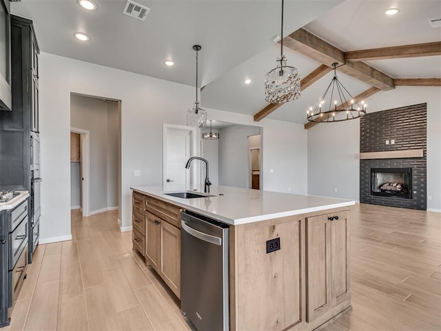 kitchen featuring a center island with sink, pendant lighting, sink, and appliances with stainless steel finishes