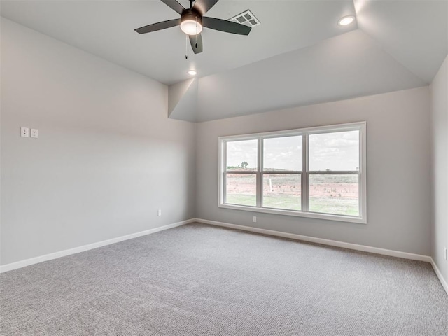 carpeted empty room featuring vaulted ceiling and ceiling fan