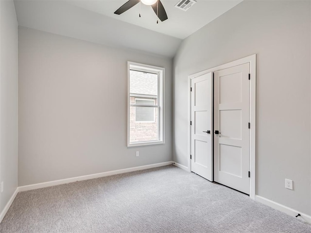 unfurnished bedroom with light colored carpet, ceiling fan, and lofted ceiling