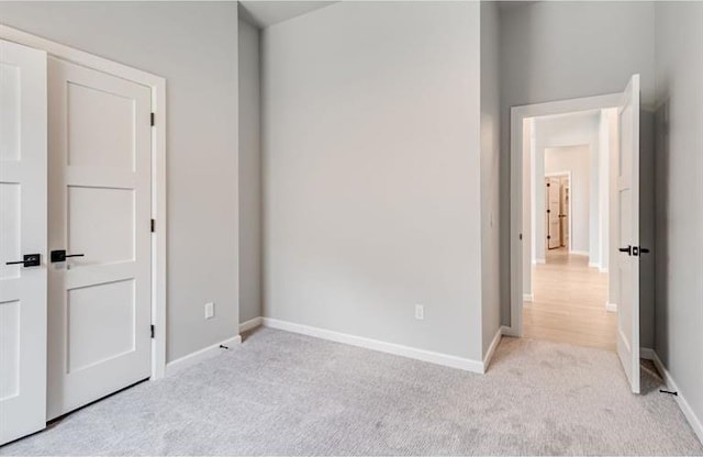 unfurnished bedroom featuring light carpet