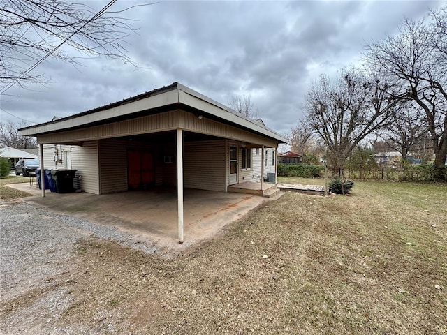 view of side of property featuring a yard and a carport