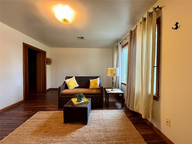 sitting room featuring dark wood-type flooring