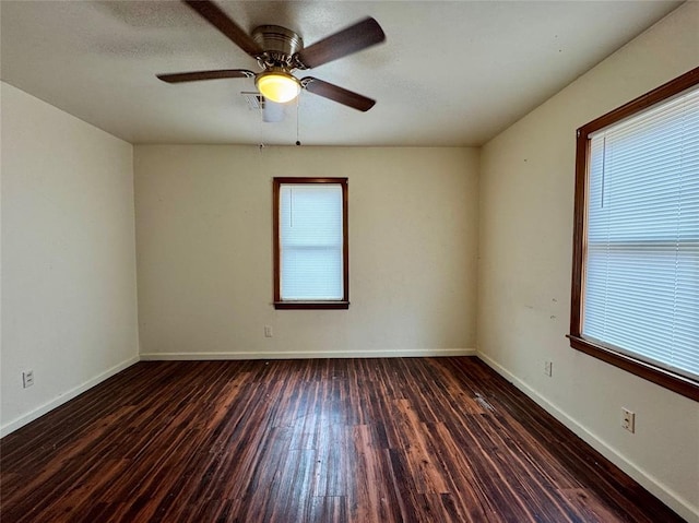 spare room featuring a textured ceiling, dark hardwood / wood-style flooring, a wealth of natural light, and ceiling fan