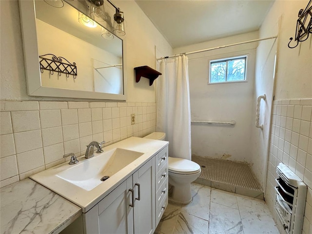 bathroom featuring curtained shower, heating unit, toilet, vanity, and tile walls