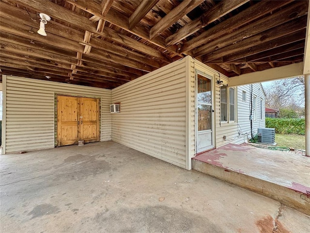 exterior space featuring central AC unit, a patio, and a wall unit AC