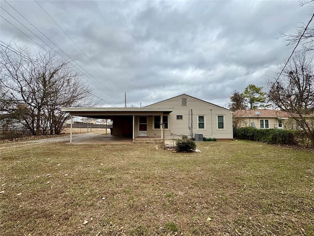 rear view of house with a yard and a carport