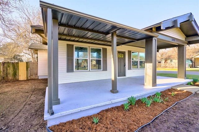 exterior space with fence and covered porch