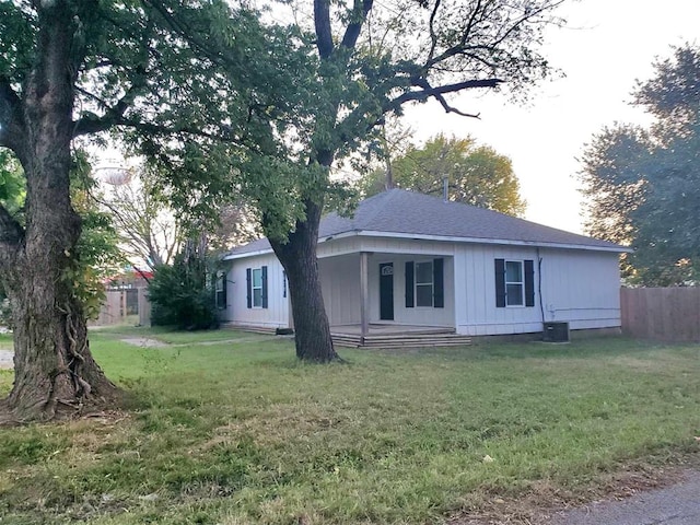 view of front of home with a front lawn and central air condition unit