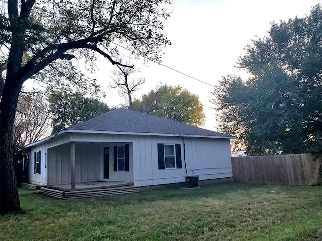 rear view of property featuring a lawn