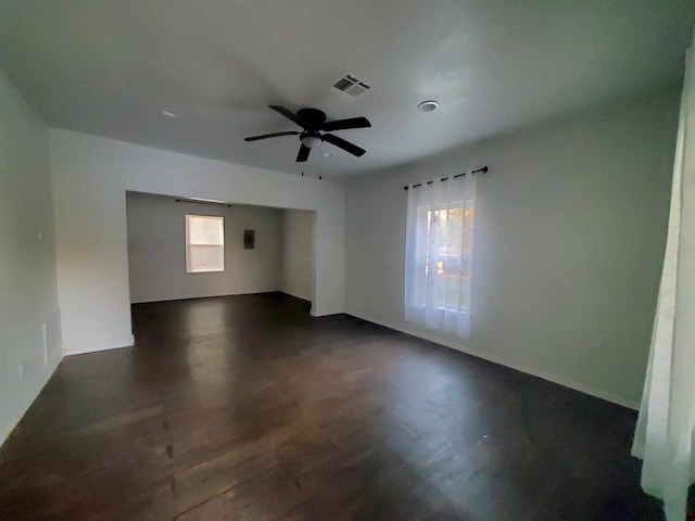 unfurnished room featuring ceiling fan and dark wood-type flooring