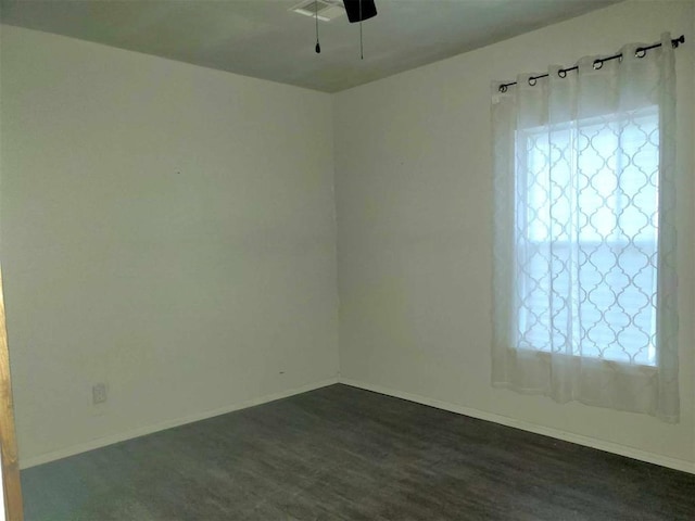 spare room featuring dark hardwood / wood-style floors and ceiling fan