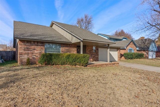 single story home featuring a front lawn and a garage