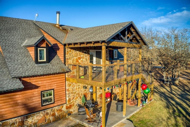 rear view of property with a patio area and a wooden deck