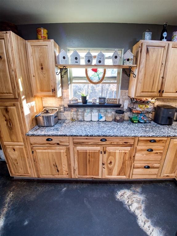 kitchen featuring backsplash and light brown cabinetry