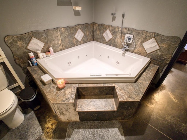 bathroom with tile patterned flooring, toilet, and a bathing tub