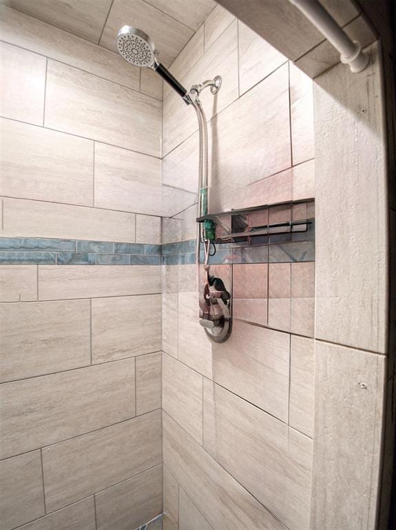 bathroom with tiled shower