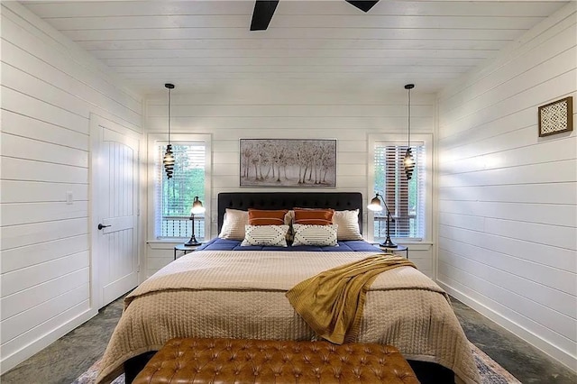 bedroom featuring ceiling fan and wood walls