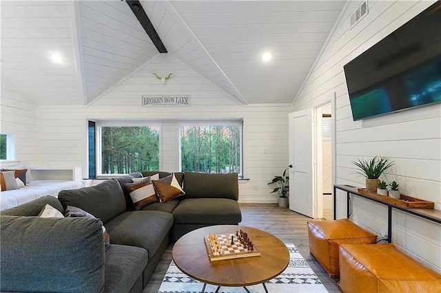 living room with light wood-type flooring, high vaulted ceiling, wooden walls, and wood ceiling