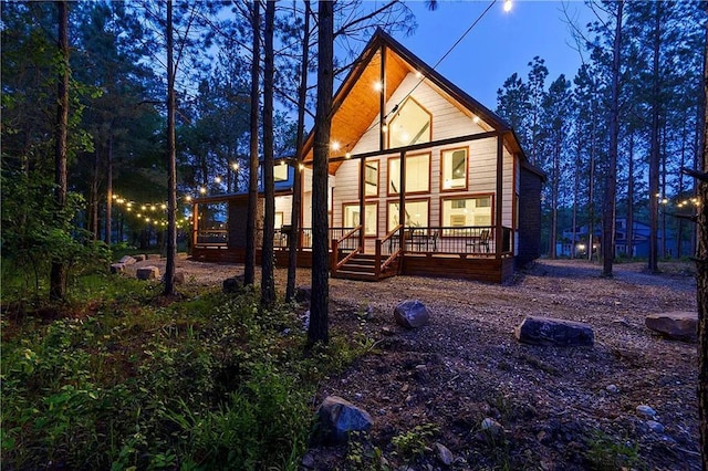 rear view of property featuring a wooden deck