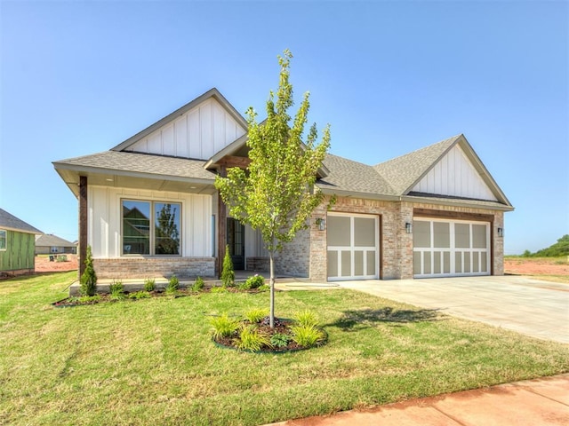 craftsman inspired home featuring a front yard and a garage