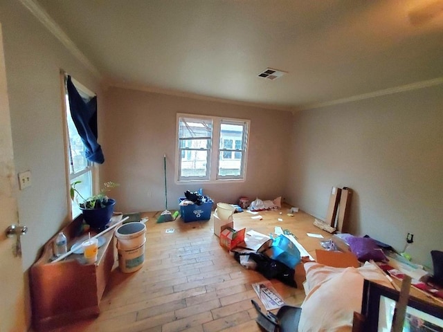 interior space with light hardwood / wood-style flooring and ornamental molding