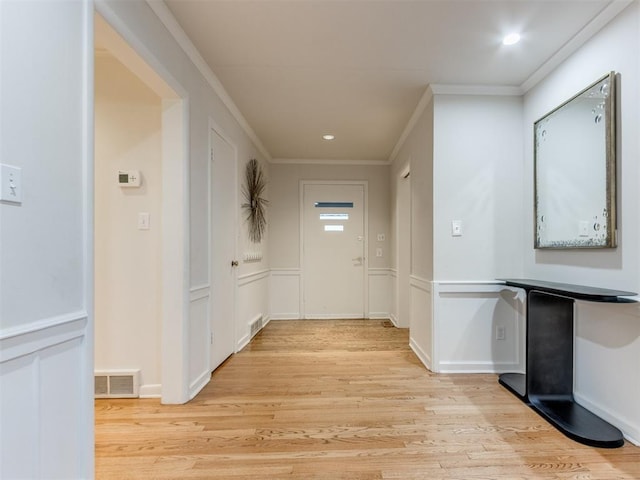 corridor featuring crown molding and light wood-type flooring