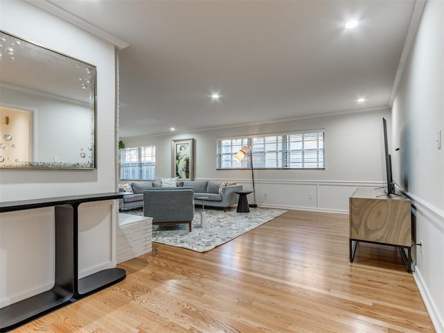 living room featuring light hardwood / wood-style floors and ornamental molding