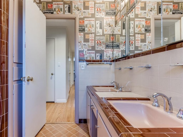 bathroom with tile patterned floors, vanity, and tile walls