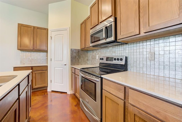 kitchen with appliances with stainless steel finishes and tasteful backsplash