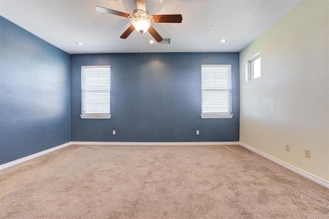 carpeted empty room featuring ceiling fan