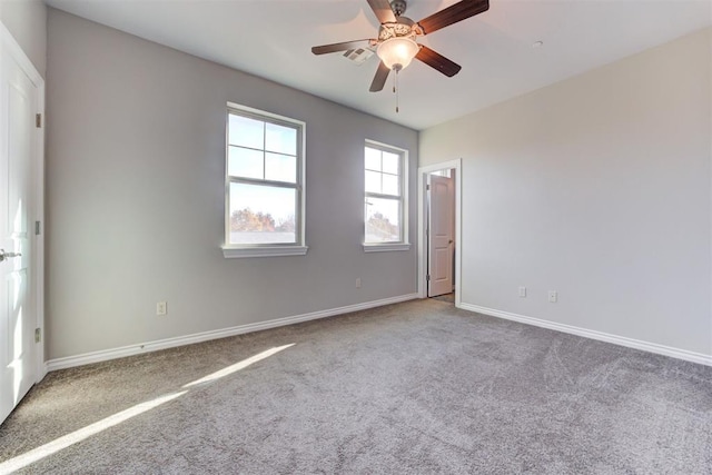 carpeted empty room featuring ceiling fan