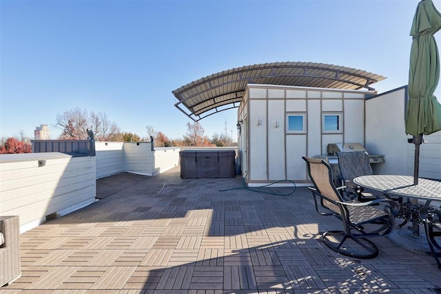 view of patio / terrace with a jacuzzi and central air condition unit