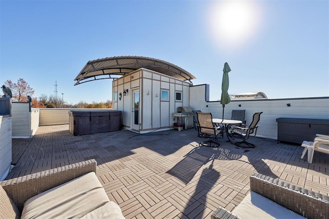 view of patio / terrace with grilling area and a hot tub