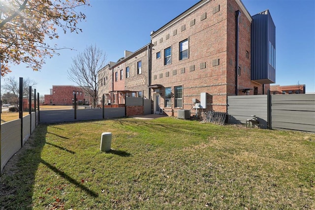 view of property exterior featuring a yard and central AC