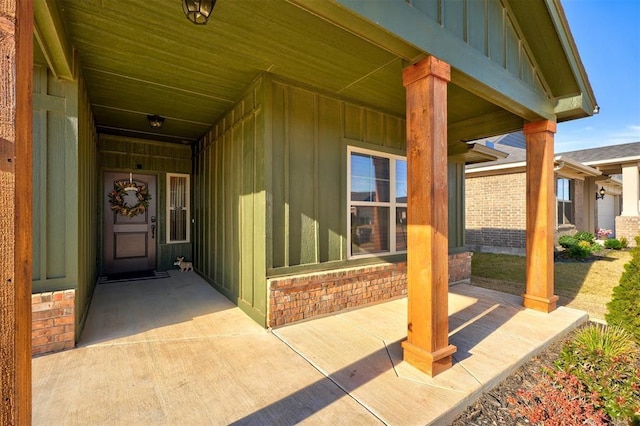 view of exterior entry featuring covered porch