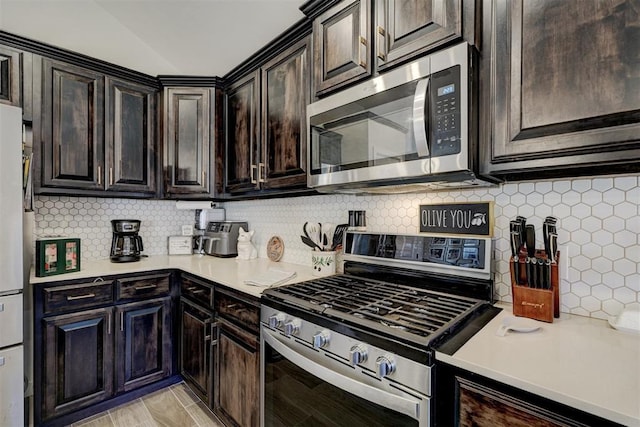 kitchen featuring dark brown cabinets, appliances with stainless steel finishes, and decorative backsplash