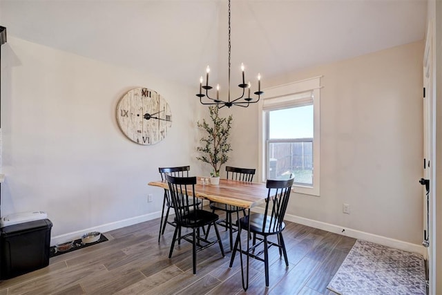 dining area featuring an inviting chandelier and dark hardwood / wood-style flooring