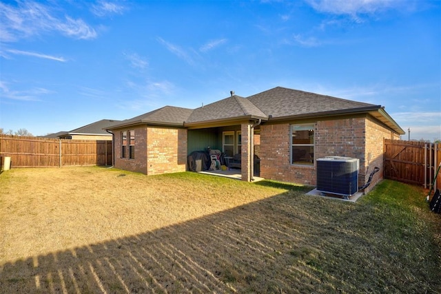 back of house with a yard, central AC unit, and a patio area