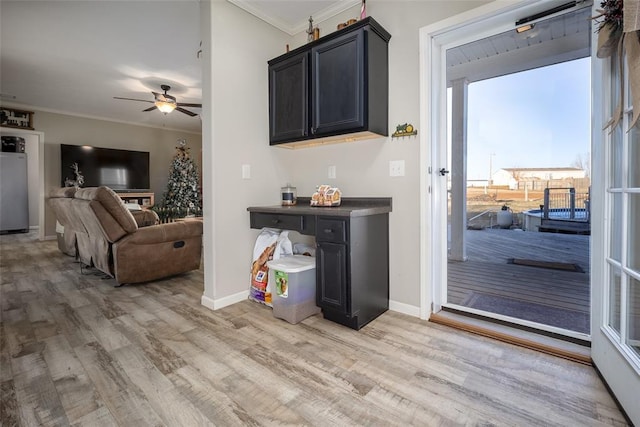 interior space featuring light hardwood / wood-style flooring, ornamental molding, and ceiling fan