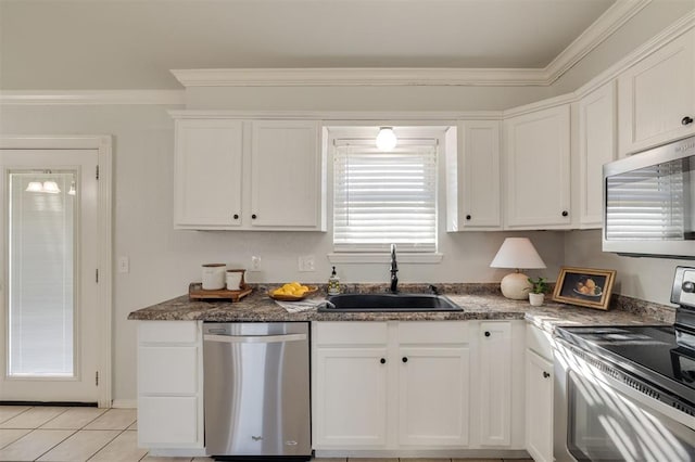 kitchen featuring appliances with stainless steel finishes, white cabinetry, crown molding, and sink