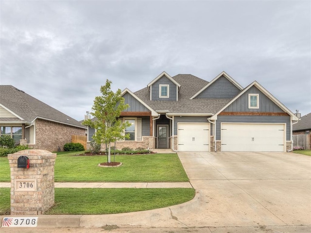 craftsman inspired home with board and batten siding, concrete driveway, a front lawn, and a shingled roof