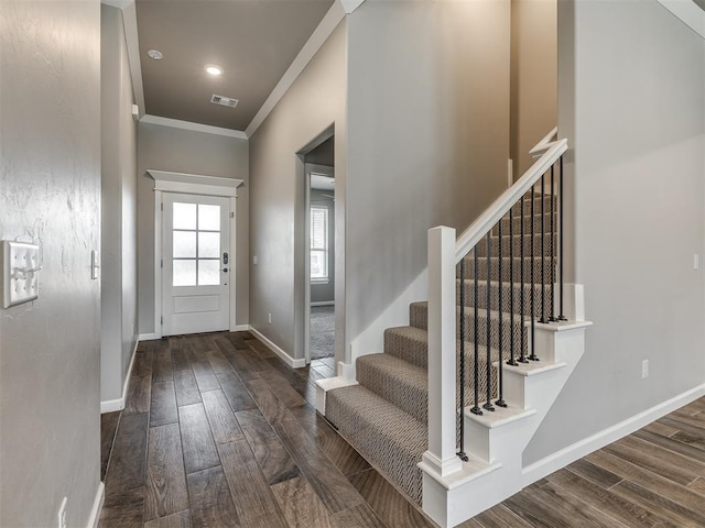 entrance foyer featuring baseboards, visible vents, wood finish floors, stairs, and crown molding