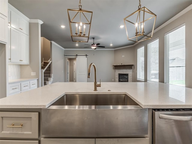 kitchen with recessed lighting, ceiling fan with notable chandelier, and ornamental molding