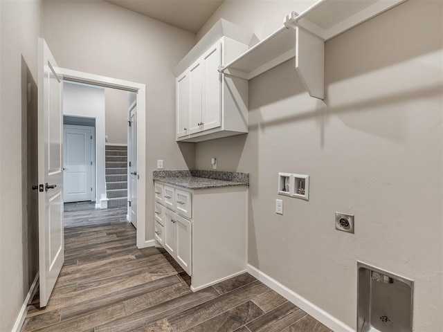 washroom with baseboards, hookup for an electric dryer, cabinet space, dark wood-style flooring, and washer hookup