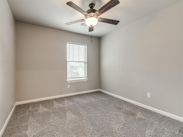 carpeted empty room featuring visible vents, baseboards, and ceiling fan