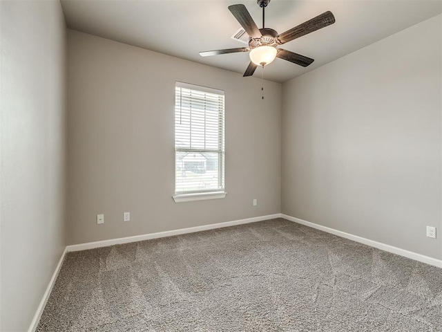 spare room with baseboards, ceiling fan, and carpet flooring